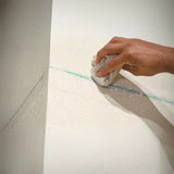 Spray-Lock FRP adhesive — wiping overspray from a wall with a damp cloth